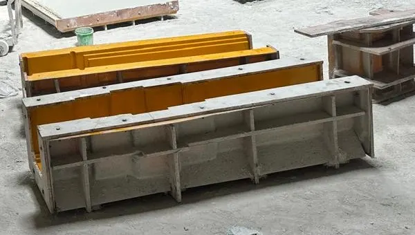 Long yellow-lined moulds for GRC cornice profiles in the casting hall