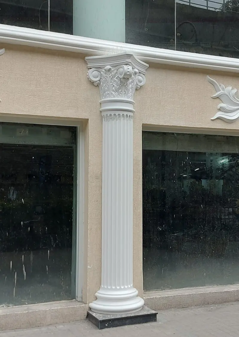 A fluted column with a Corinthian capital beside a shopfront at 1 MG-Lido Mall