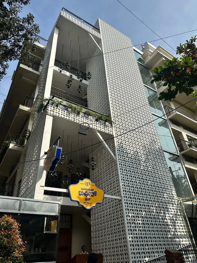 Indian Tiffin Club building faced with full-height white jali screens