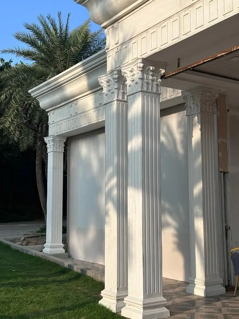 Paired fluted columns with ornate capitals at a corner of the Princess Golf building