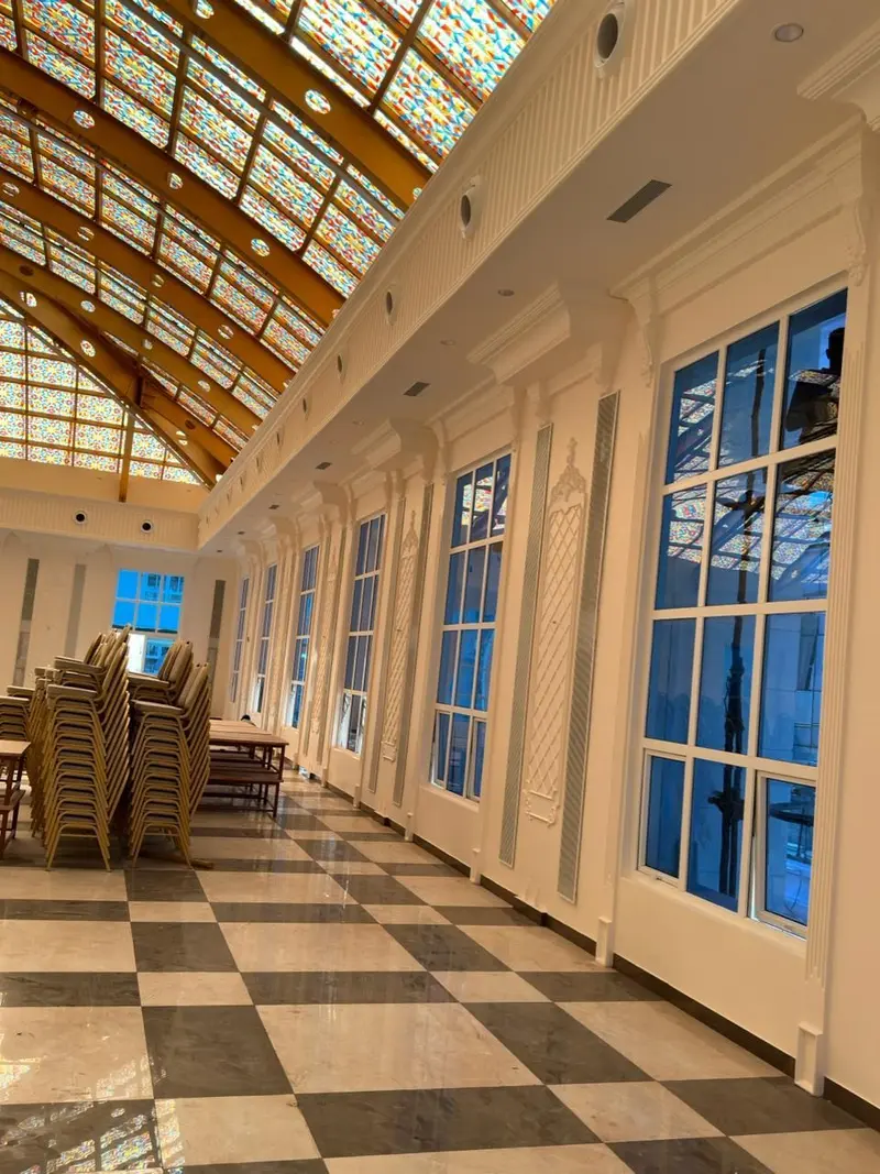 Pilasters and window surrounds along the hall wall
